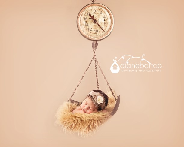 newborn girl on a vintage scale photo riverside