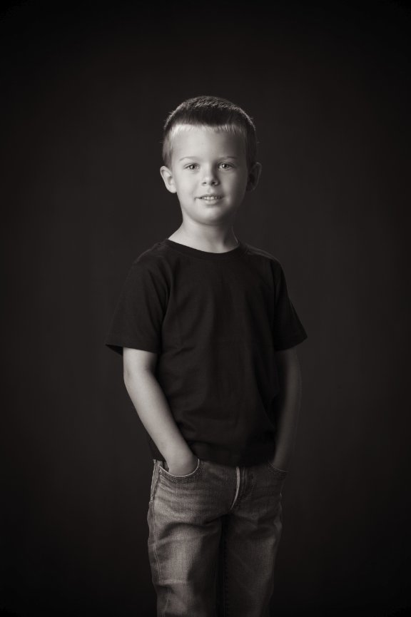 Black and white studio portrait of boy