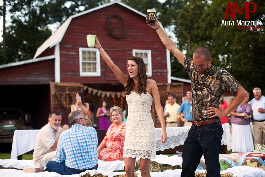 Hay bales covered with sheets make a great sitting area at this Rustic DIY barn wedding in Seagrove, NC. © Aura Marzouk Photography