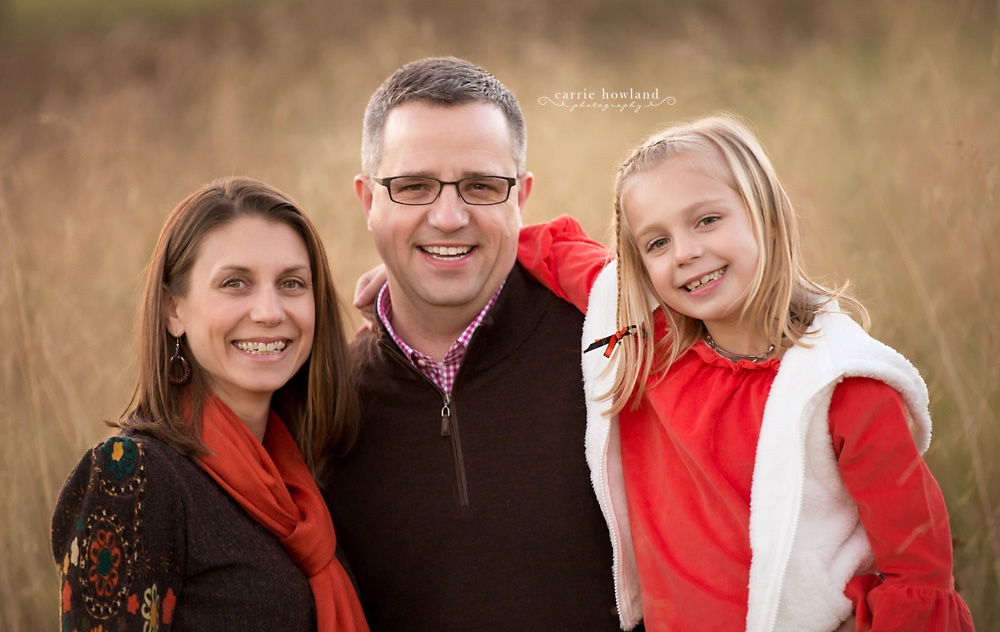 family_of_three_portrait_orange_and_brown_rich_tones_winery_in_troutman