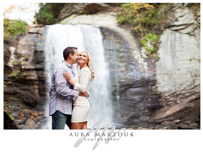 Hands make a heart with a lovely sun backdrop at this Pisgah National Forest engagement session. © Aura Marzouk Photography, Greensboro Wedding Photographer