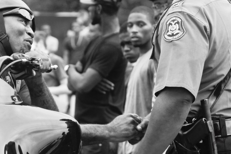 Man shakes cops hand.  ©Phoebe Landrum Photography  Ferguson Protest - A regional issue — at Ferguson, Saint Louis, Missouri.
