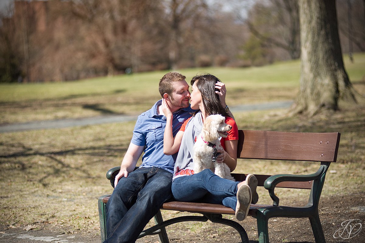 couple kissing in park, pet engagement photo, engagement photos at washington park albany, albany engagement photography, downtown engagement session, albany portrait photography, engagement session in washington park
