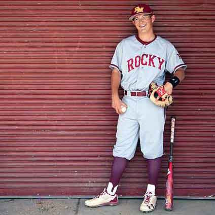 High school senior wearing a baseball uniform during a personalized portrait session. Captured to celebrate athletic journey and senior milestone. Luxury senior portrait experience—Fort Collins and Loveland photographer.