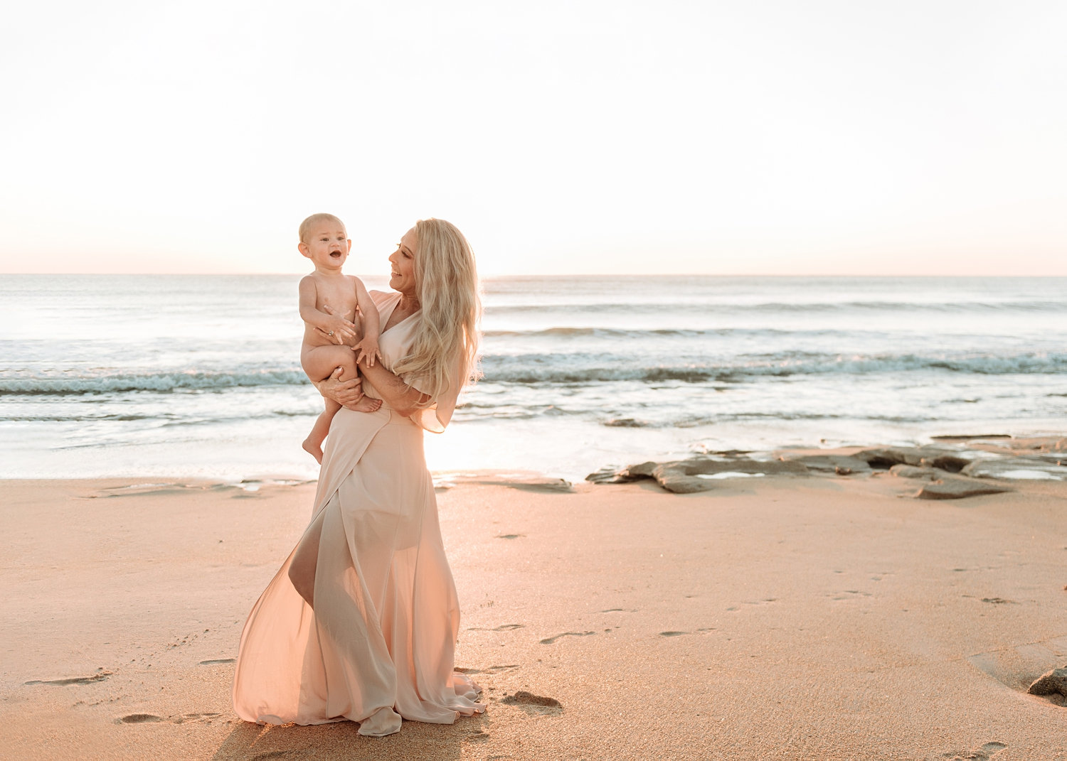 gorgeous blonde mother and baby boy dancing on the beach, Rya Duncklee