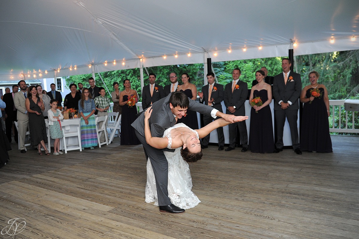 photo of groom dipping bride during their first dance