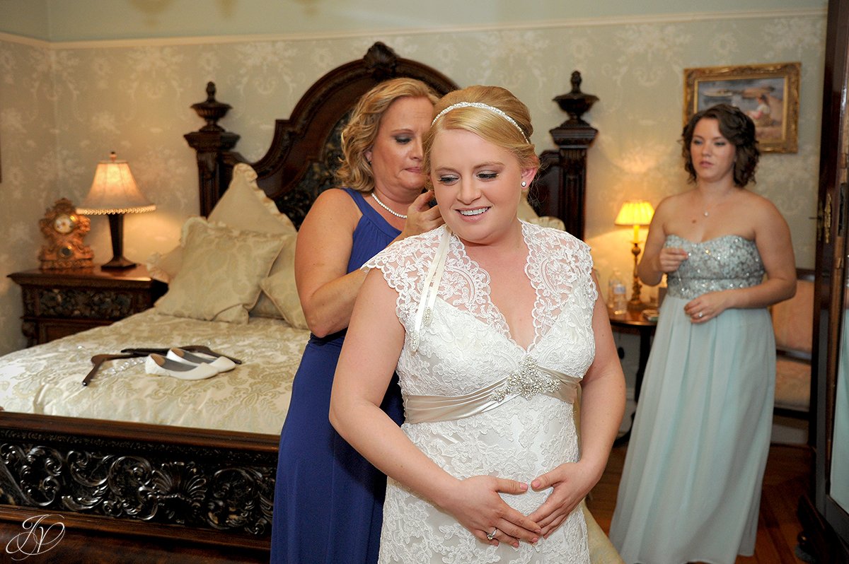 beautiful bride prepping for wedding with mother