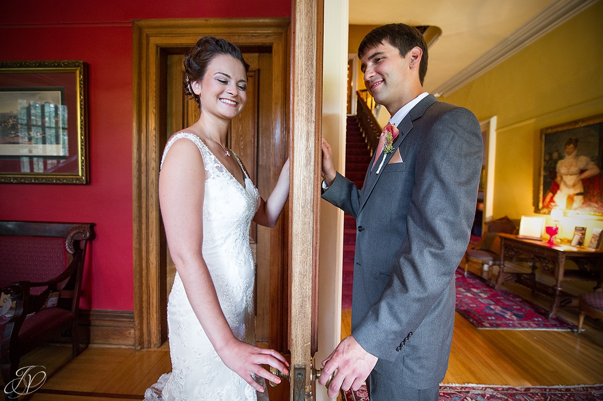 bride and groom on opposite sides of a door