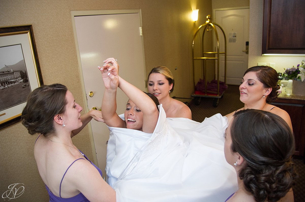 unique angle of bride getting dressed