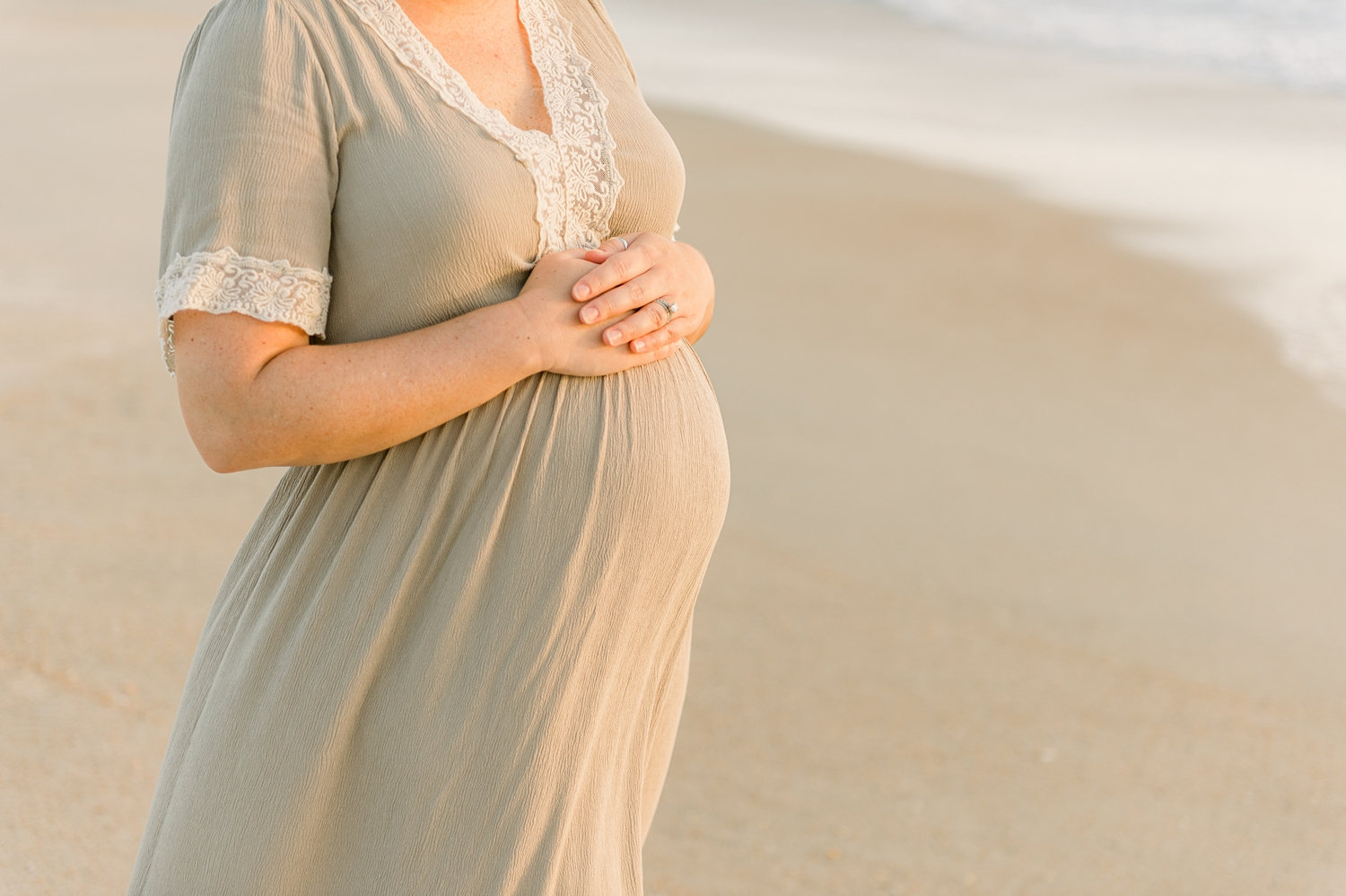 mother to be resting her hands on her pregnant bump, Ryaphotos