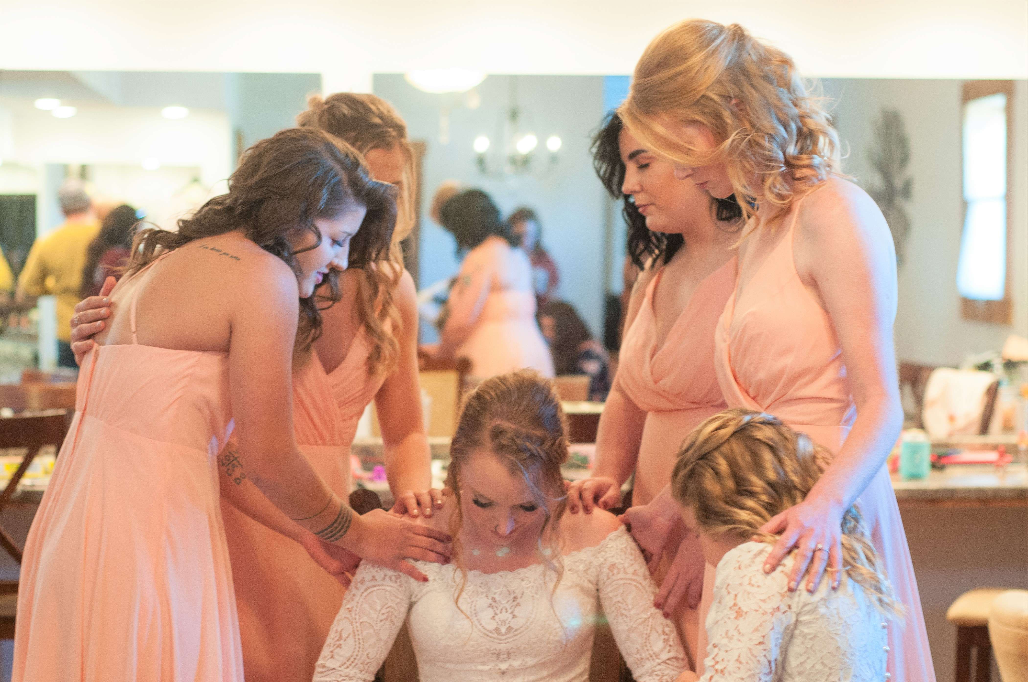 Maid of honor saying a pray for the bride before the ceremony.