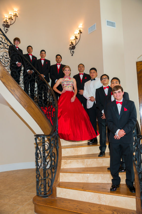 Group portrait on staircase with quinceañera in red gown