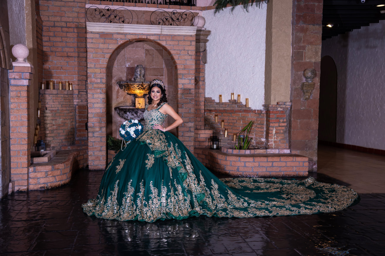 Young woman in green gown at an ornate venue