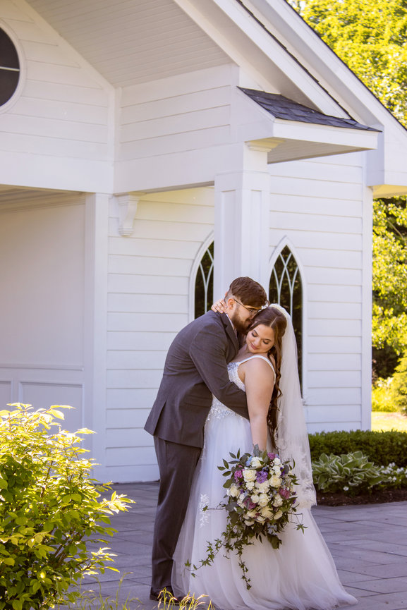 Couple sharing a close kiss in a forest
