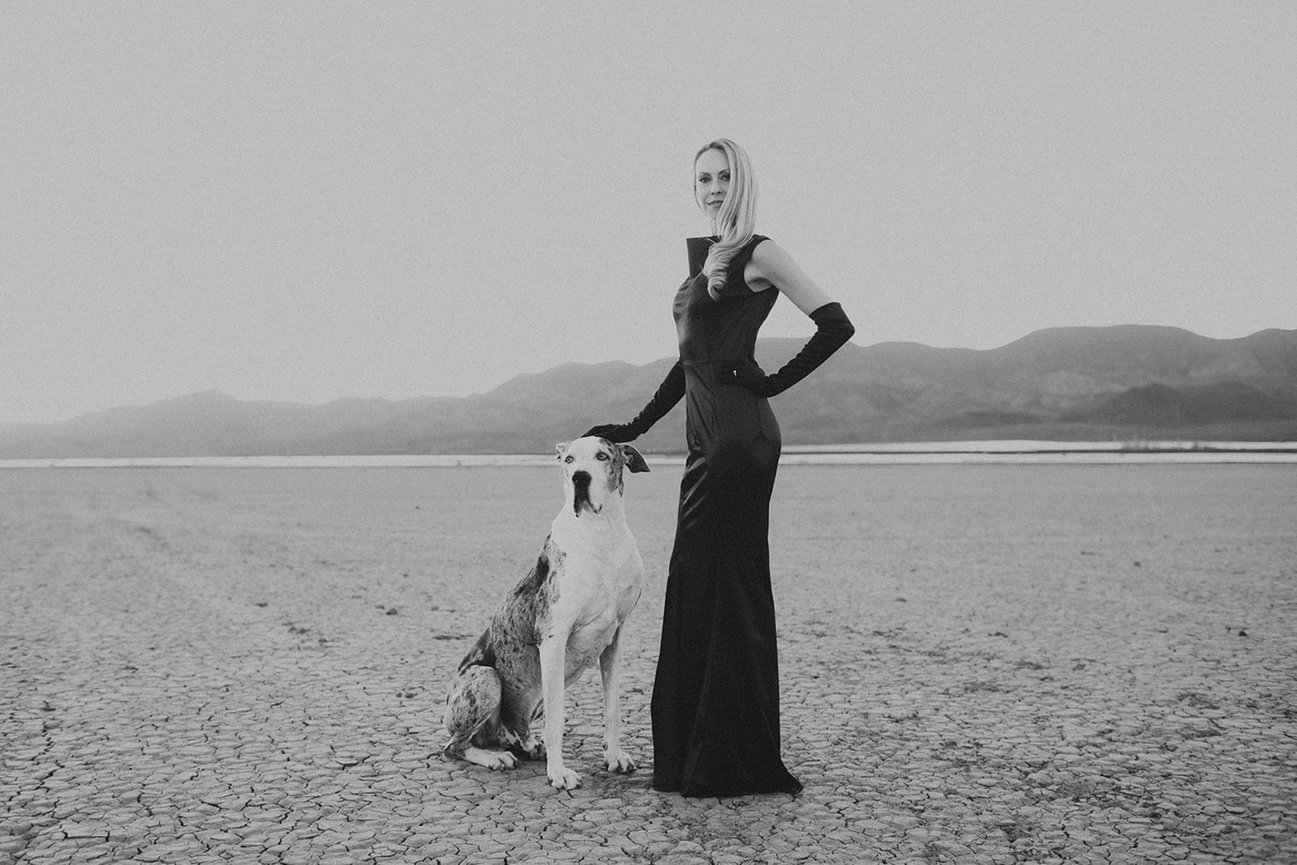 Dry lake bed black and white portrait of Great Dane and Woman in black dress take by Adam Trujillo. Professional picture taken by Adam Trujillo, a Las Vegas studio portrait photographer.