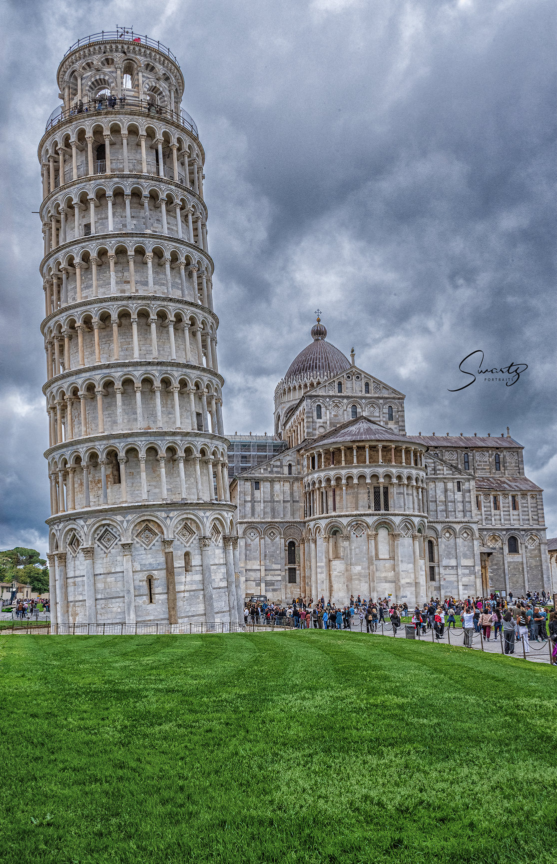 A landscape portrait of the Leaning Tower of Pisa. This is a different angle most people don't seel.