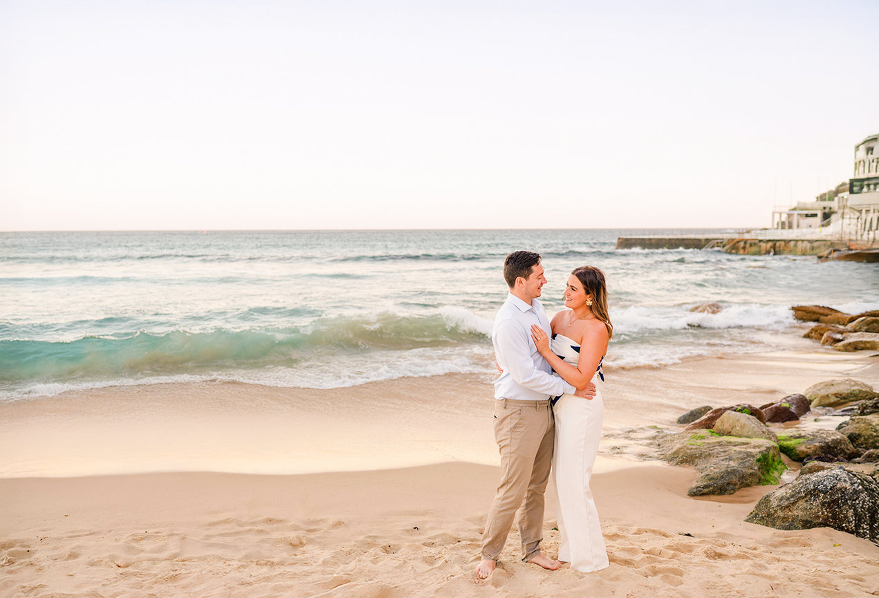 Couple looking at each other during a Bondi beach couple vacation photoshoot.