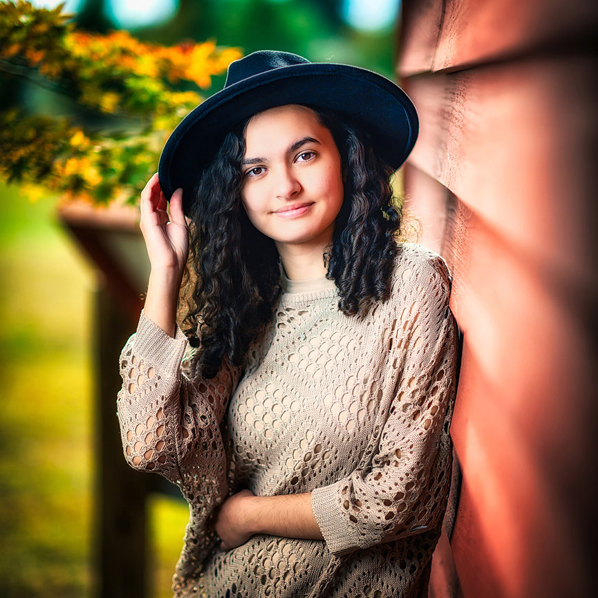 High school senior girl portrait in autumn light against historic brick wall — fine art editorial photography by Master Photographer Ty Swartz, Swartz Portraits Katy Sugar Land Texas senior portraits