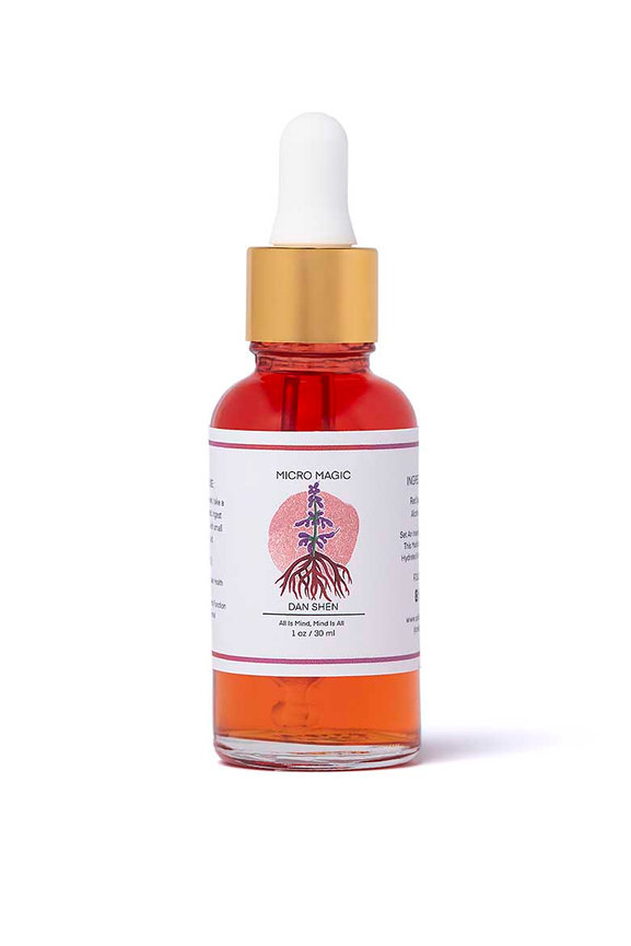 Orange dropper bottle of mushroom tincture on white background