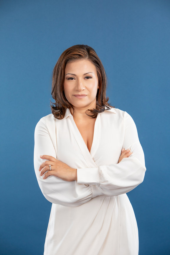 contemporary portrait woman with serious expression and white suit with crossed arms