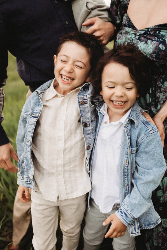 Two brothers laughing during their New Jersey family photo session.