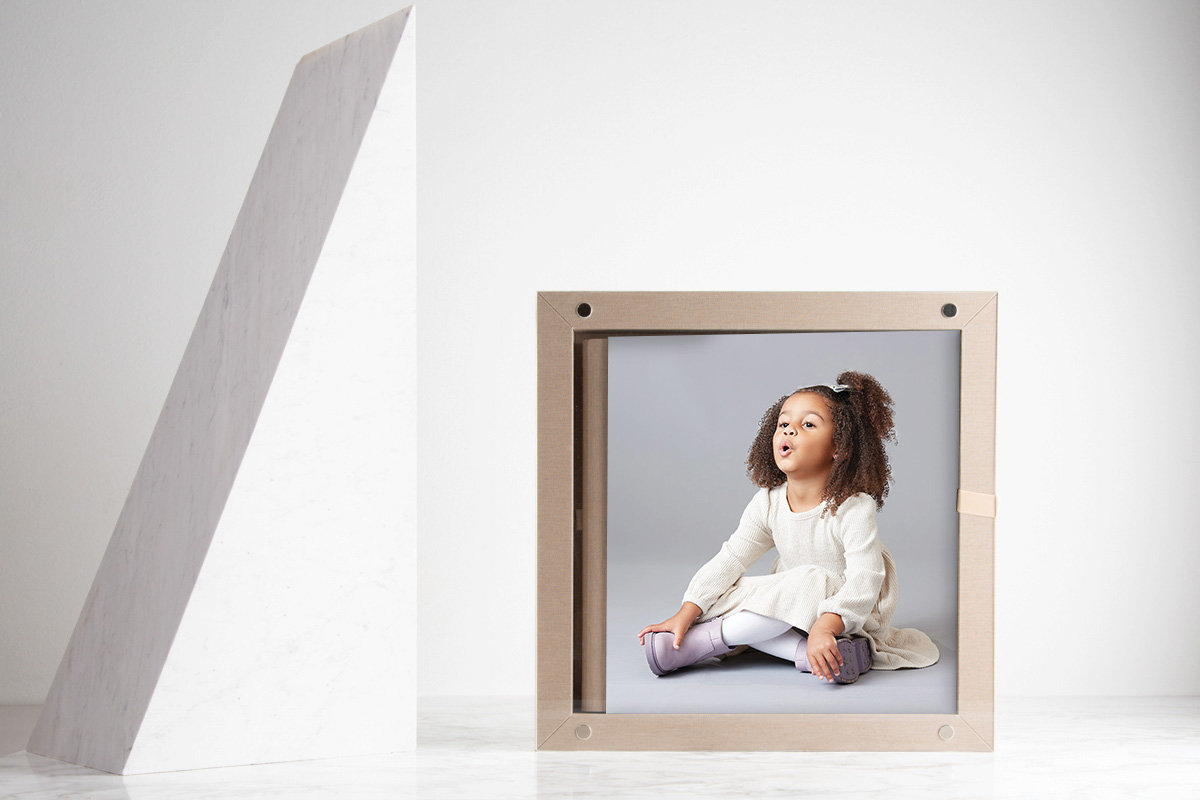 Handcrafted album with children’s portraits, presented as a refined and lasting collection of images