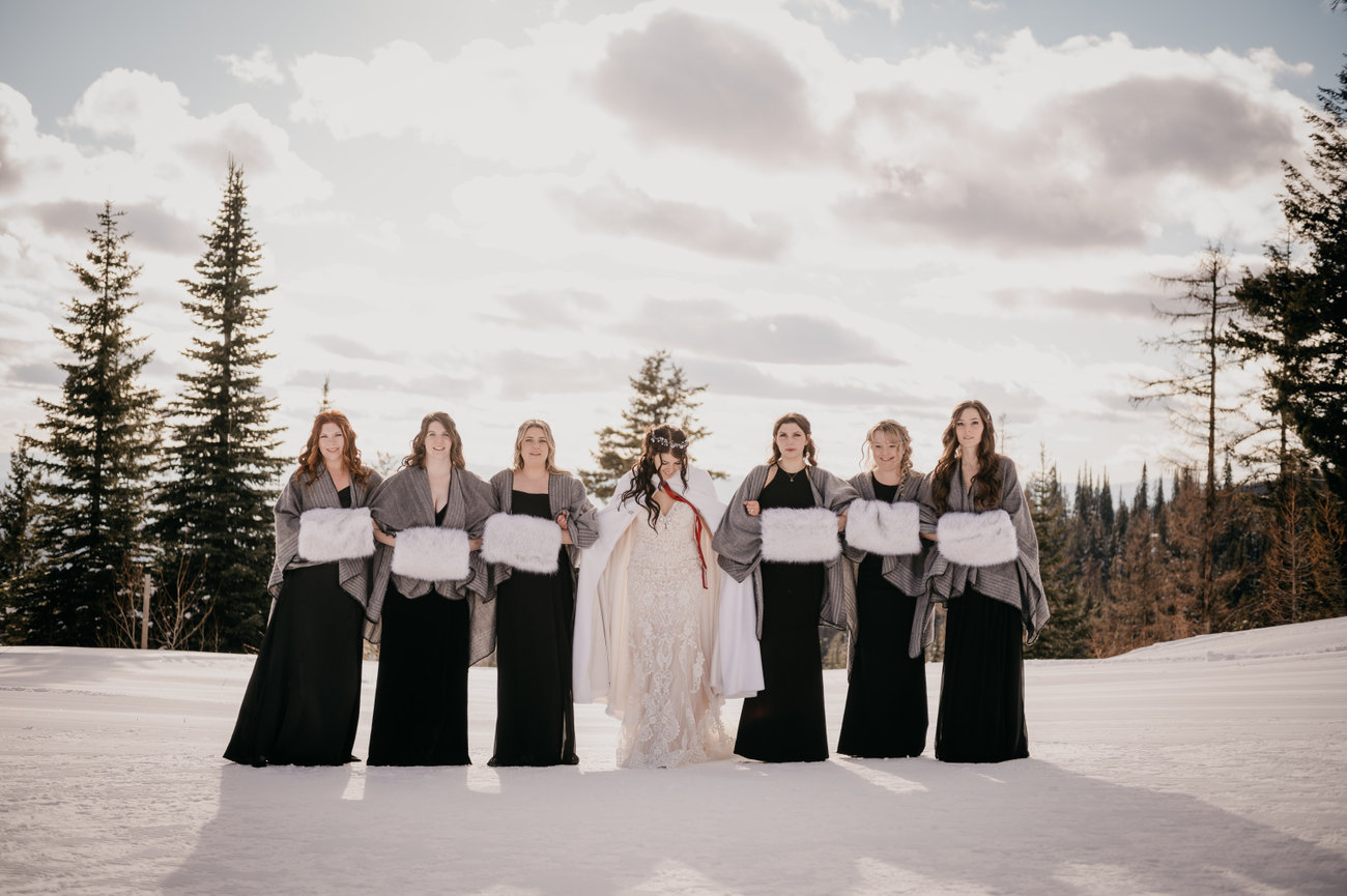 Bridal party: Joyful bridal party poses in front of a scenic Kelowna wedding location.
