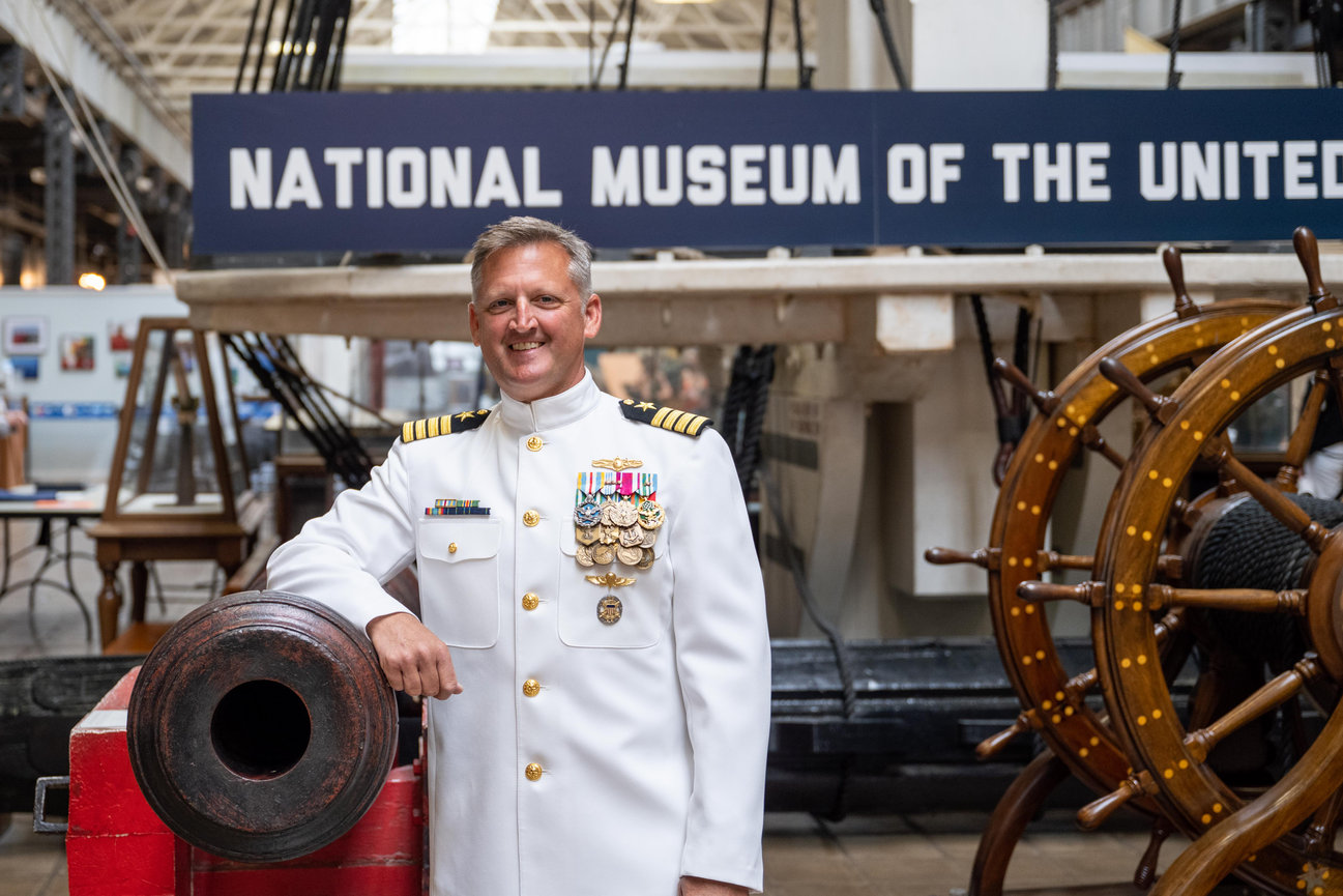 Naval Officer posing at the National Museum of the United States Navy during his retirement ceremony