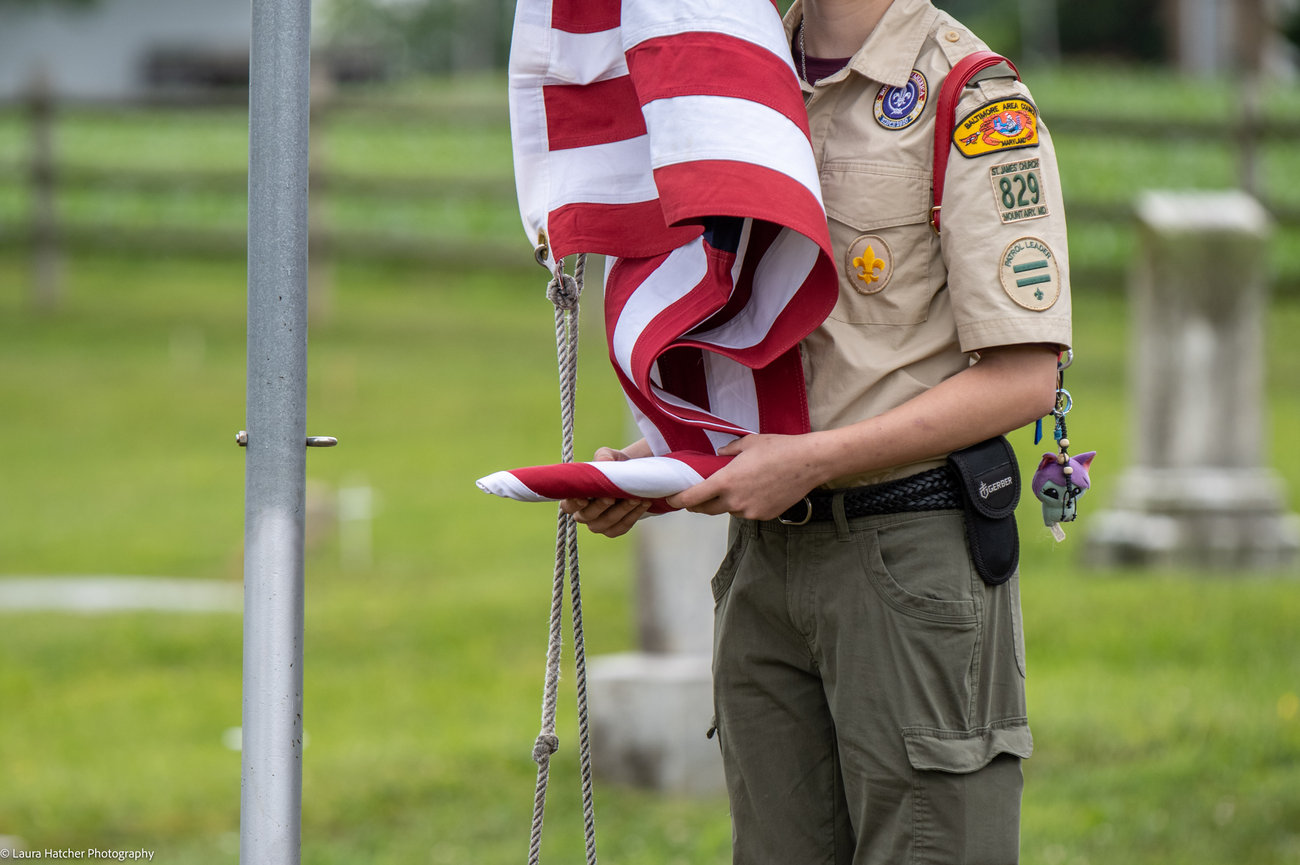 A Boy scout holding the American Flag