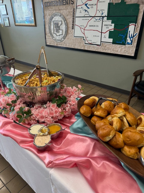Buffet table with breads and pink decor