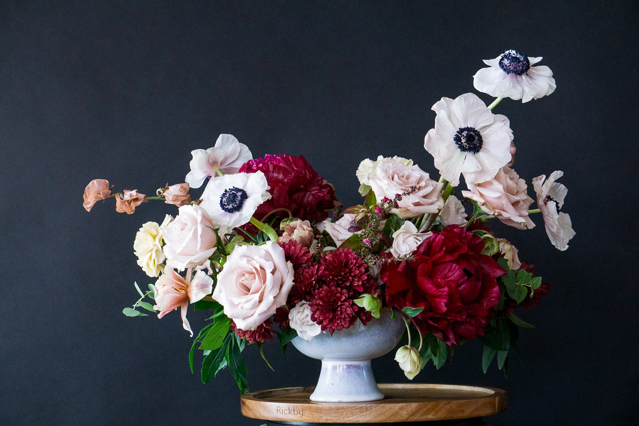 Bold and luxurious winter inspired centerpiece displaning red peonies white anemonies and Blush roses