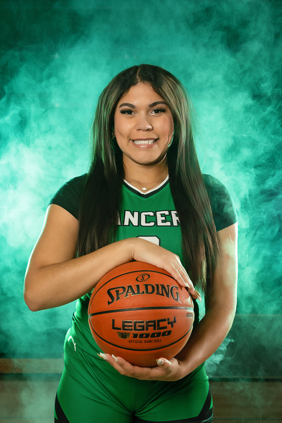 Modern studio portrait of a senior girl who plays basketball for La Crescent High School in Minnesota. Senior girl basketball portrait with elevated styling for a La Crescent High School athlete