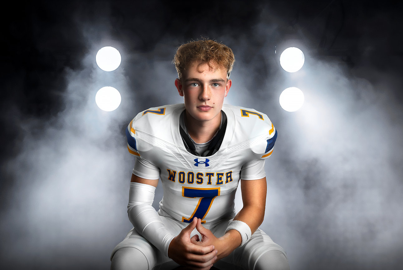 High school football player in a white Wooster uniform during session at elle lux studios