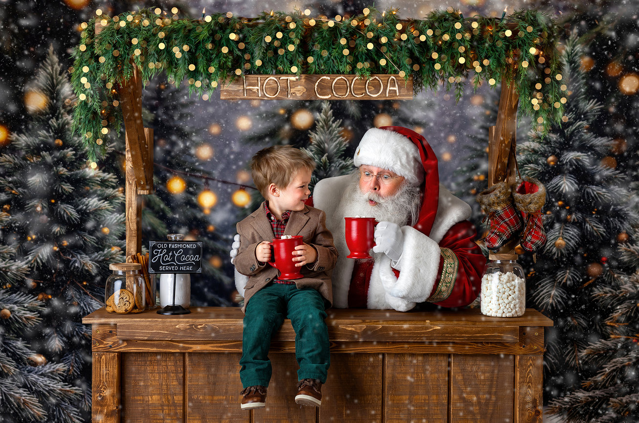 Santa Claus sharing cookies and hot cocoa with a child at an interactive Christmas mini session near Akron.