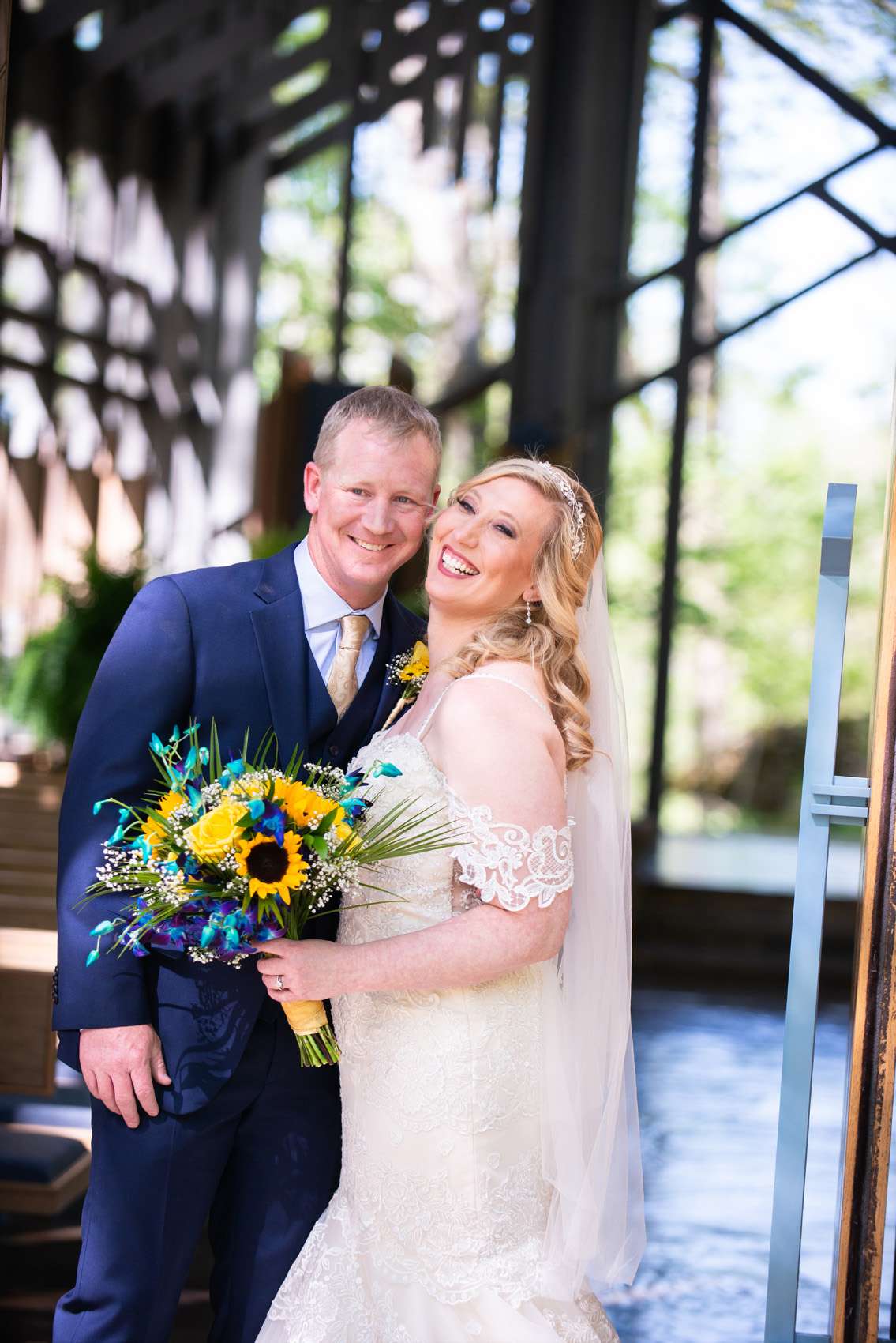 Bride and Groom smiling for photos at Thorncrown Chapel