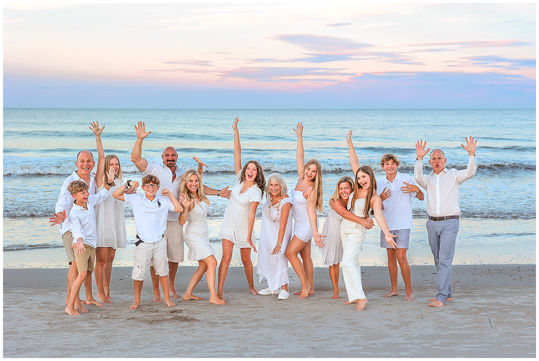 group family photo standing on the beach at sunset in Amelia Island Florida at the Omni Resort