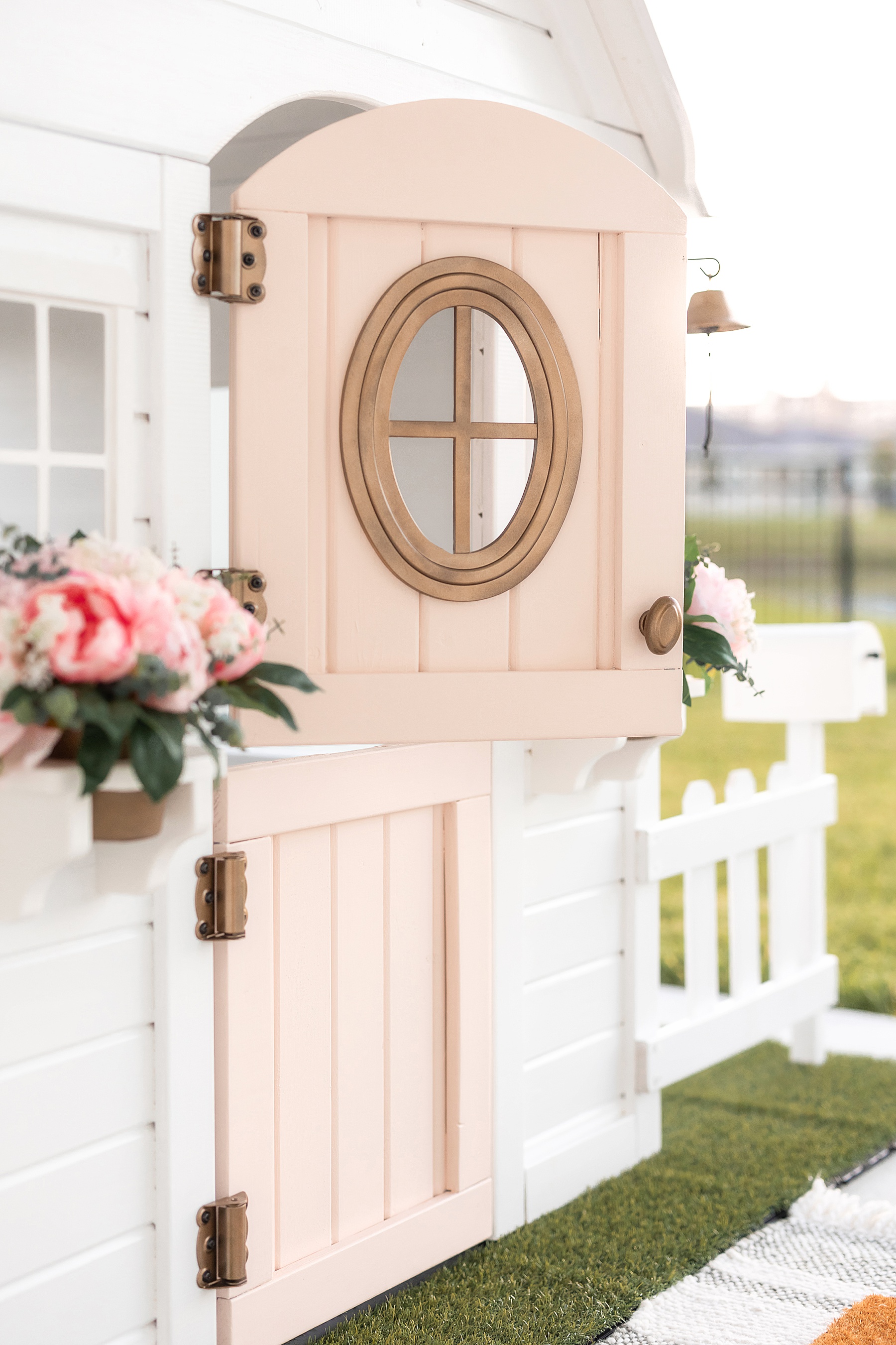 kids white playhouse with pink door