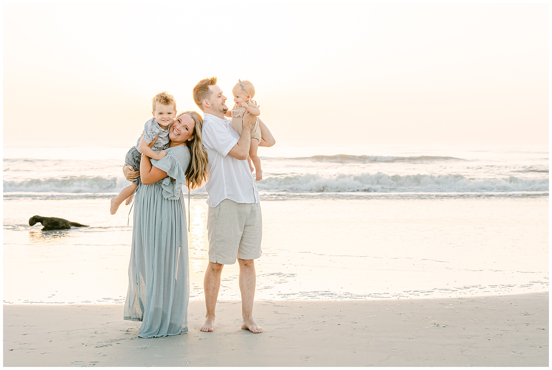 family holding children on the beach at sunrise in saint augustine