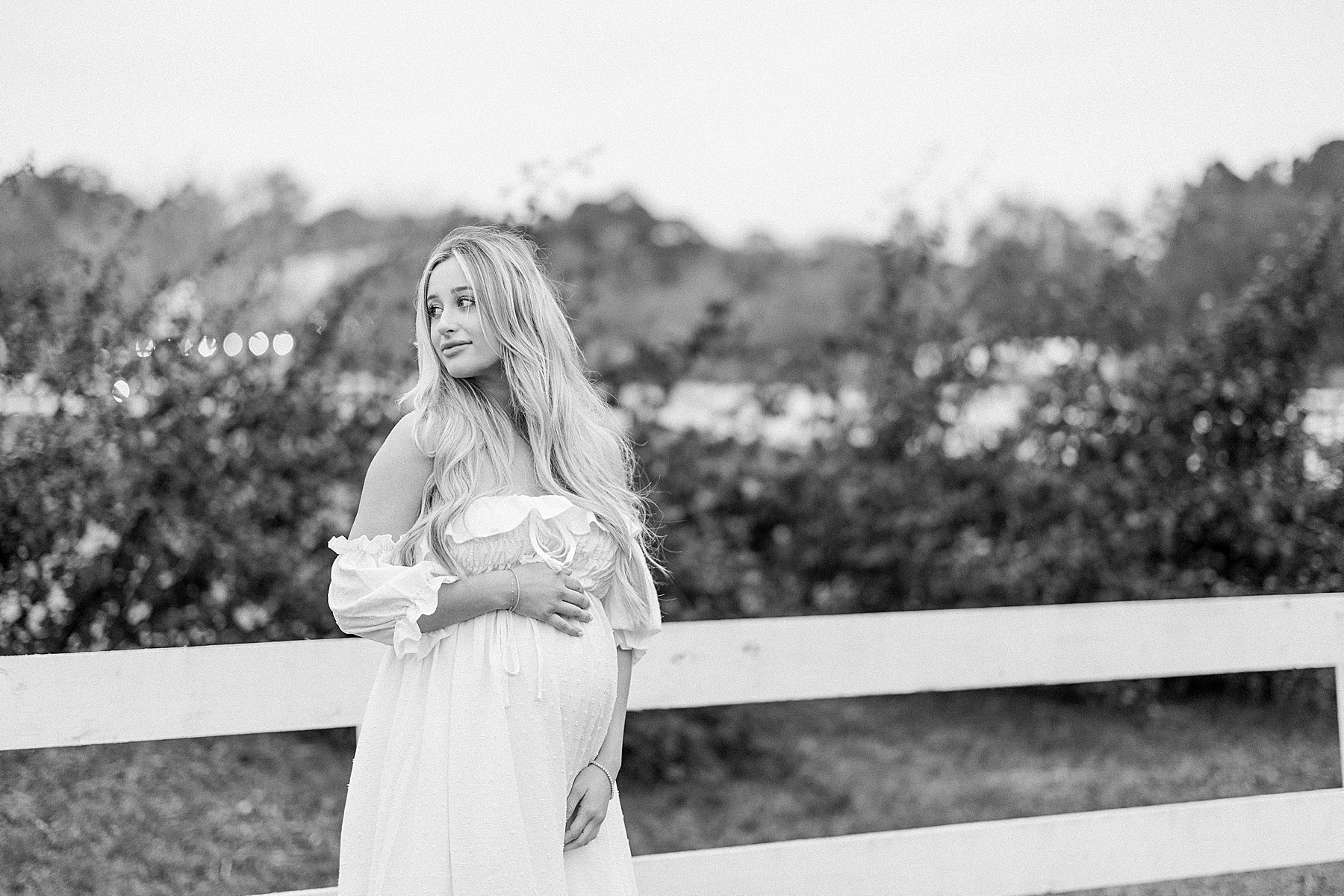 black and white maternity photograph of woman in white dress at Congaree and Penn Farm Jacksonville Florida