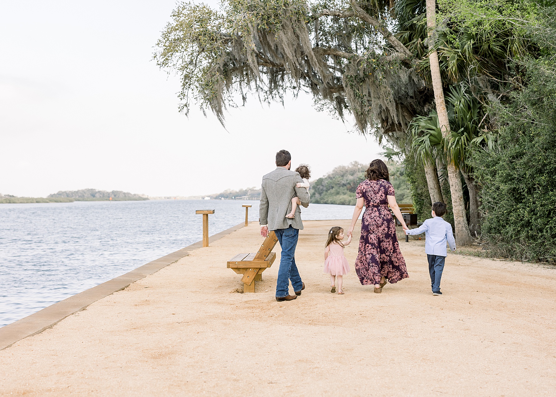 family walking along the intracoastal at washington oaks gardens and state park florida