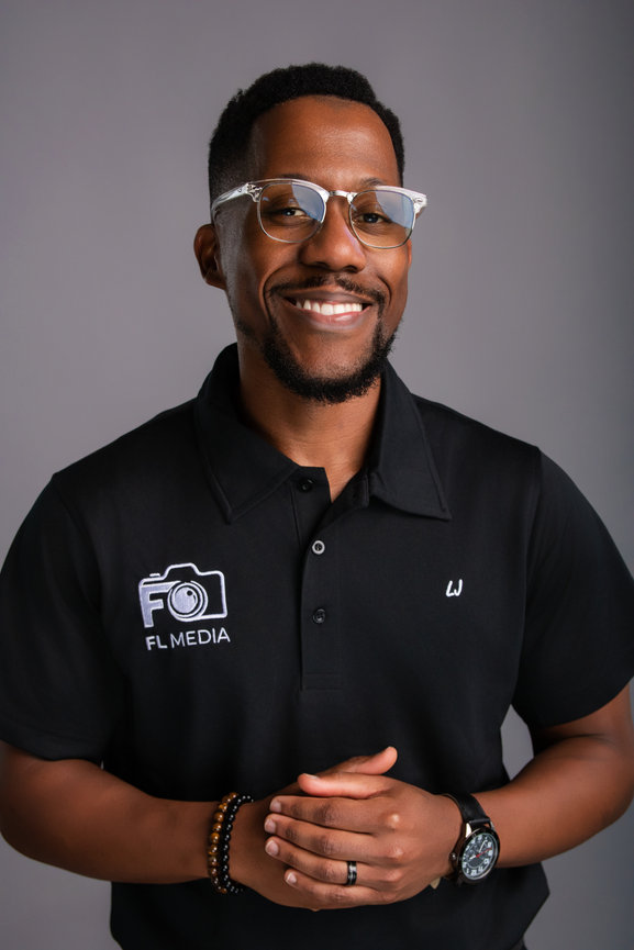 Smiling man in polo shirt with logos
