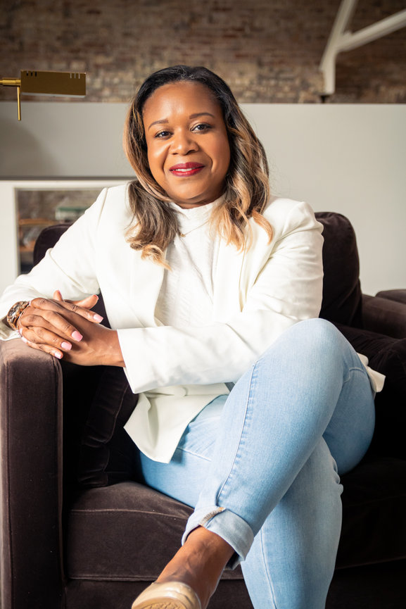 Woman in white jacket sitting on sofa
