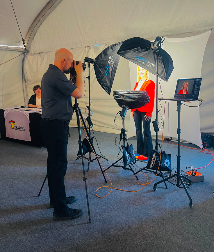 Professional event headshot booth setup at conference in Phoenix with studio lighting and branded backdrop