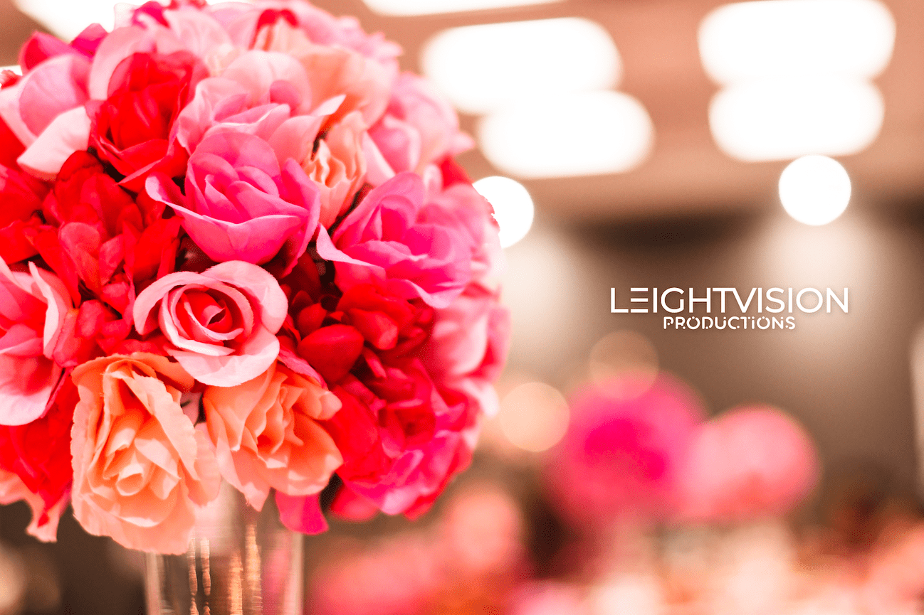 A vase filled with vibrant pink and orange flowers, showcasing a beautiful floral arrangement.