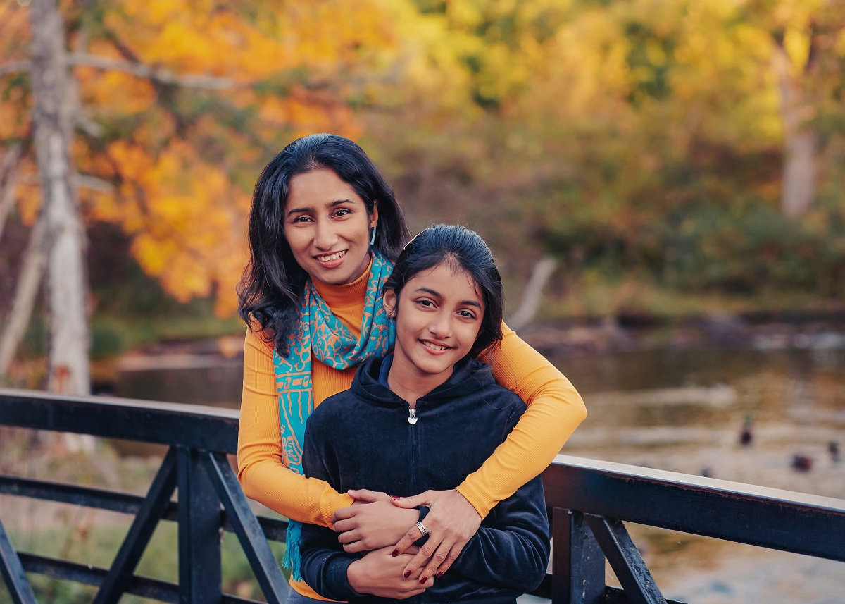 mother daughter on a bridge in the fall