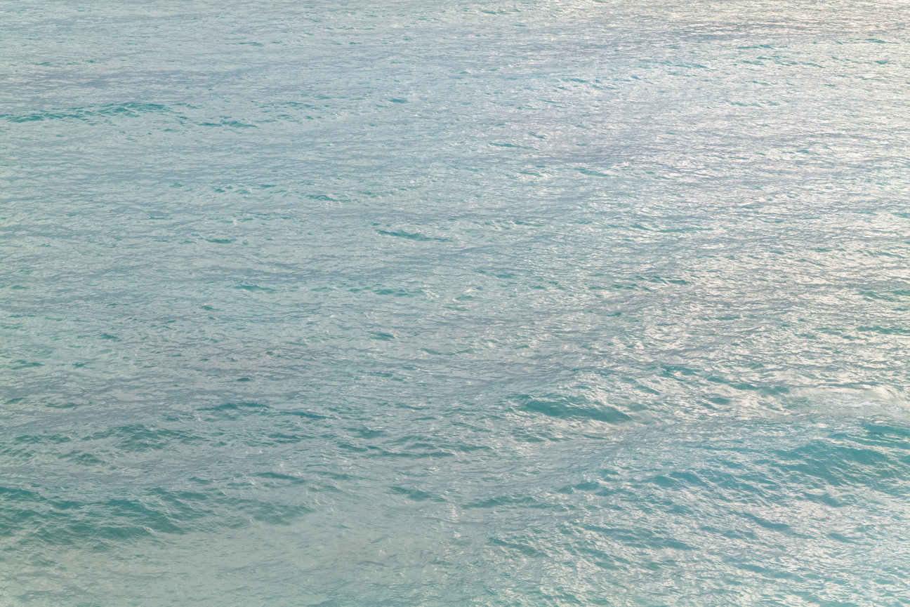 Liquid Light I - abstract ocean photography print by Andrea Bruns showing soft reflections and luminous water patterns on the Pacific surface.