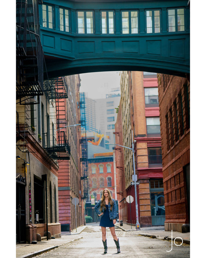 A smiling teenager stands in on Staple Street in NYC