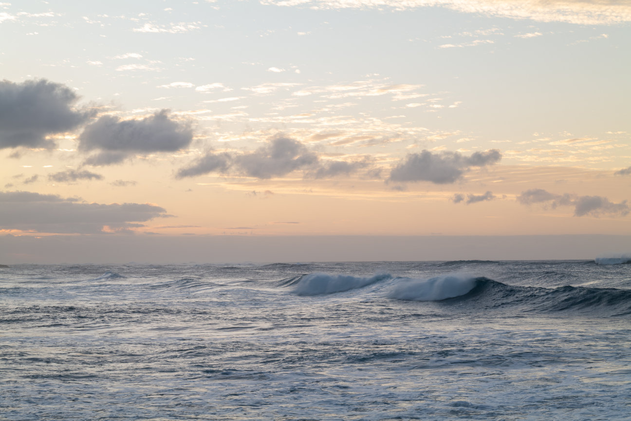 Tidal Rhythm - seascape fine art photography by Andrea Bruns of layered ocean waves under a warm pastel Pacific sky.