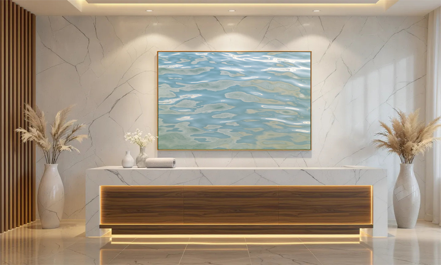 Pacific Light turquoise abstract ocean artwork by Andrea Bruns shown above a reception console in a hospitality interior.
