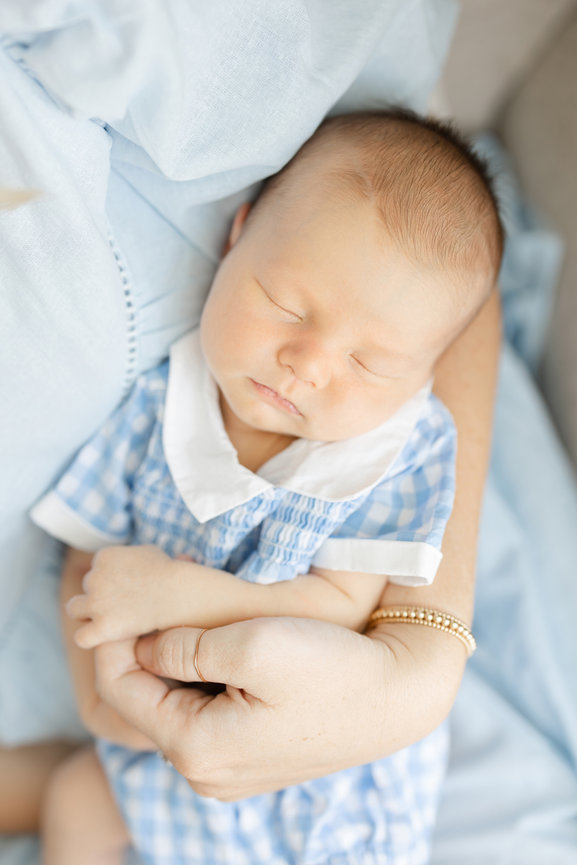 Father cradling newborn at home in St. Augustine area